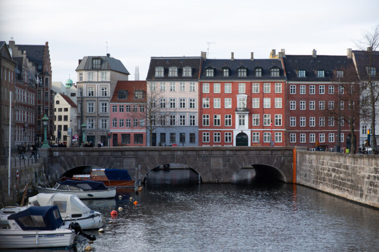 Coloured houses in a street in front of a canal